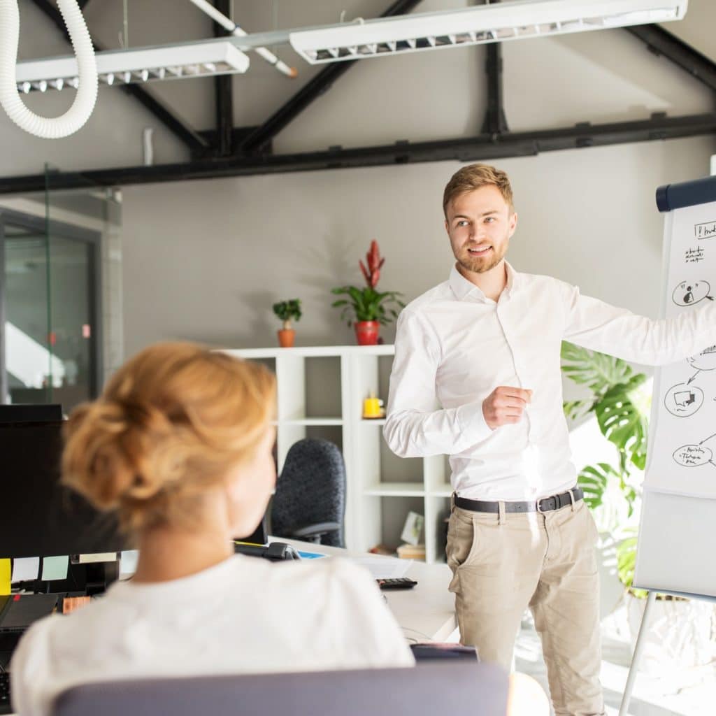 business team with scheme on flipboard at office