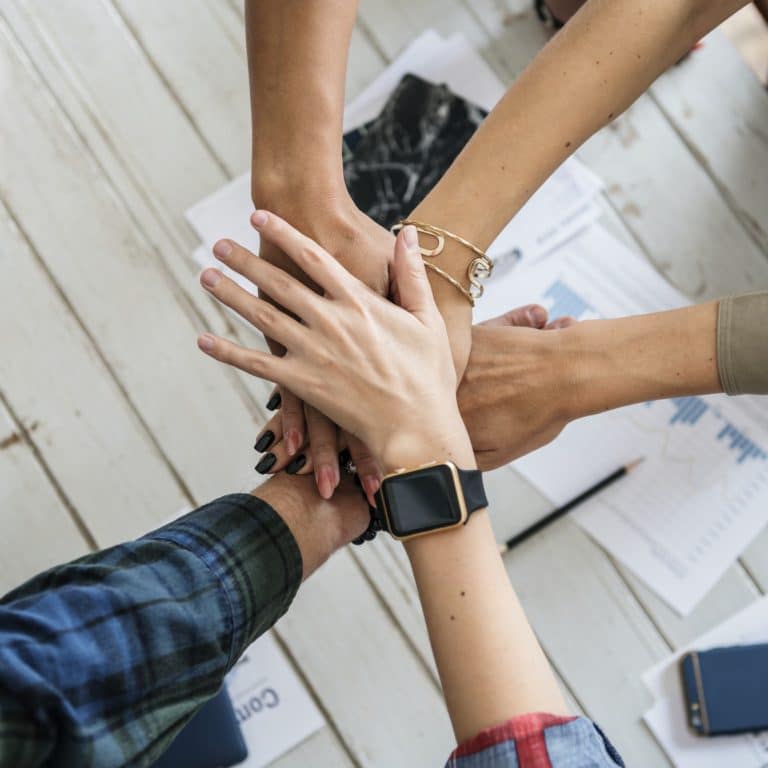 Hands stacking support each other