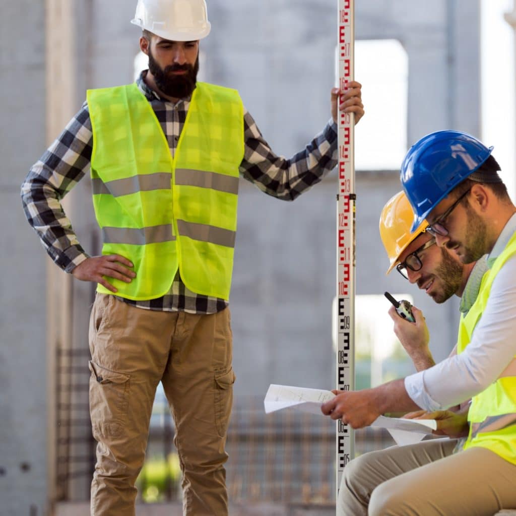 Portrait of construction engineers working on building site