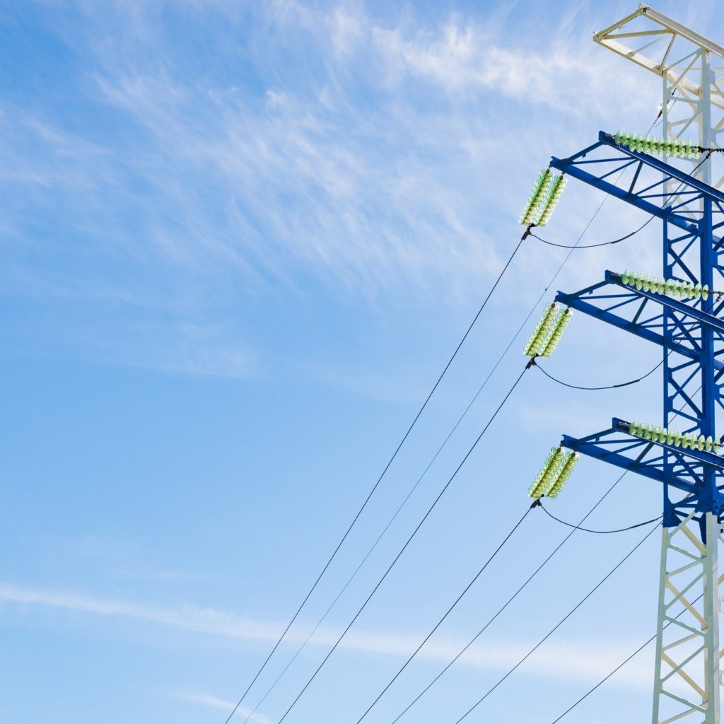 a high-voltage electricity pylons against blue sky and clouds power line electric post
