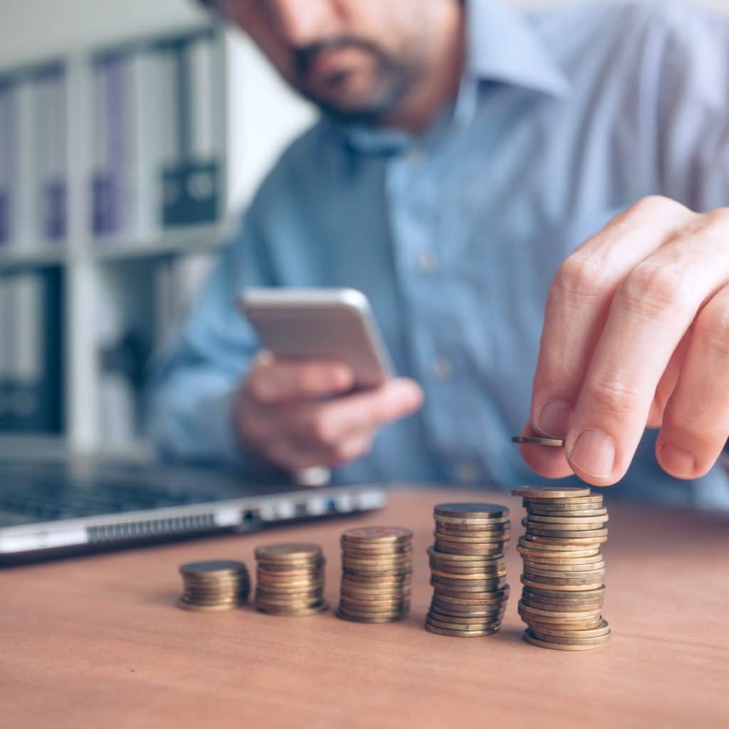 Finances and budgeting, businessman stacking coins